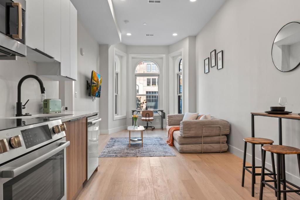 a kitchen and living room with a couch at Lux 2Bedroom apartment in Washington DC Dupont in Washington