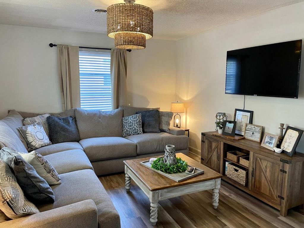 a living room with a couch and a coffee table at Cozy two-bedroom cottage close to everything! in Oak Island