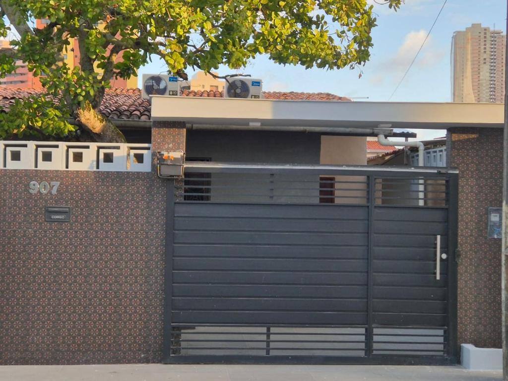 a black garage door on the side of a building at UrbanStay Flats in João Pessoa