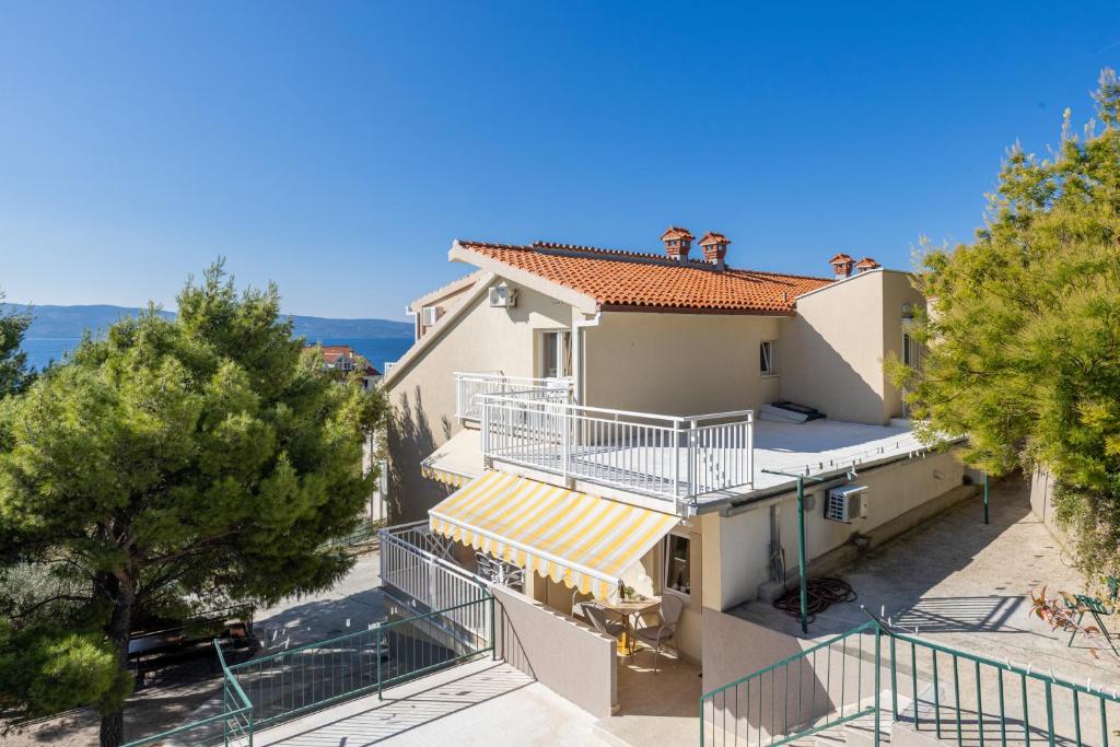 an image of a house with a balcony at Apartments by the sea Duce, Omis - 946 in Duće