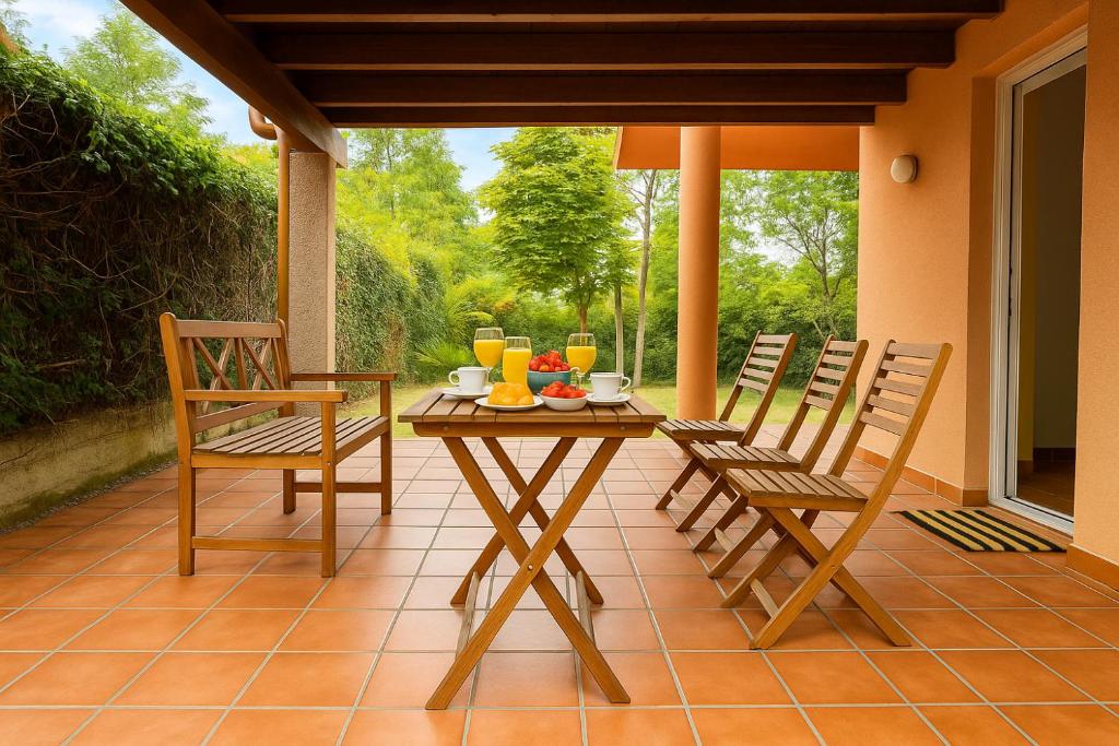 a patio with a table and chairs on a porch at Casa Vixoi, a 5Km Catedral in Santiago de Compostela