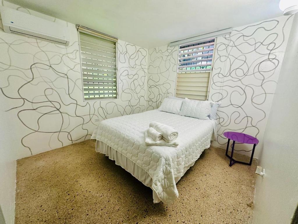 a bedroom with a bed with towels on it at 3 Bedroom Home Best Price Bayamon by Rentalspr in Bayamon