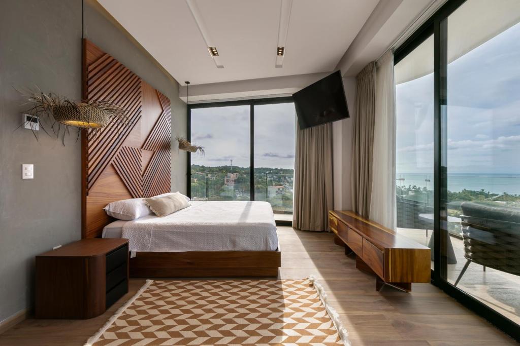 a bedroom with a bed and a large window at El Cielo Sayulita in Sayulita