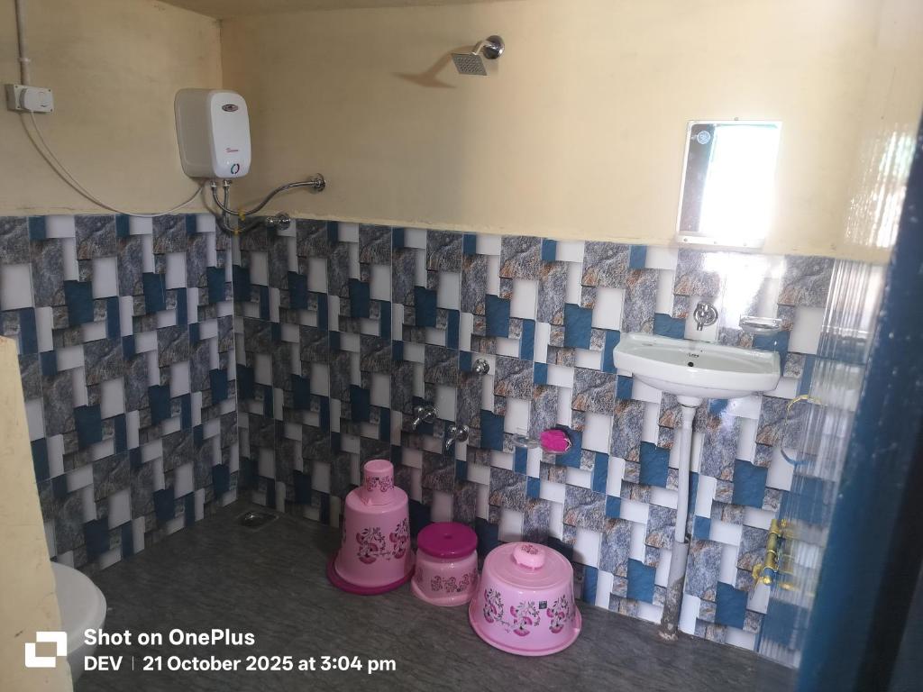 a bathroom with a sink and a toilet and a sink at Ranfamily home stay in Dhordo