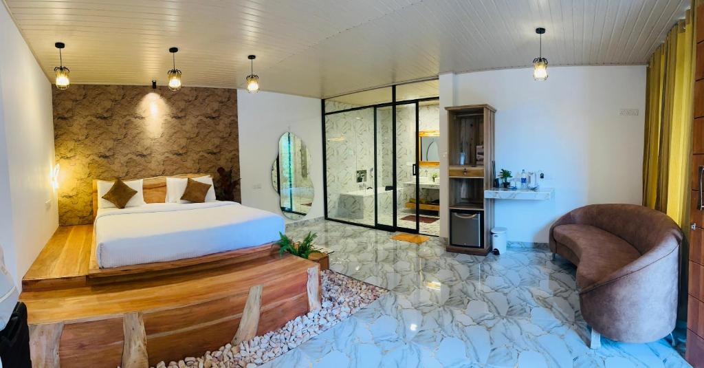 a bedroom with a bed and two chairs at The Bliss Ella in Ella