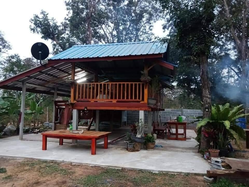 a tree house with a bench and a table at Green moon Home stay 