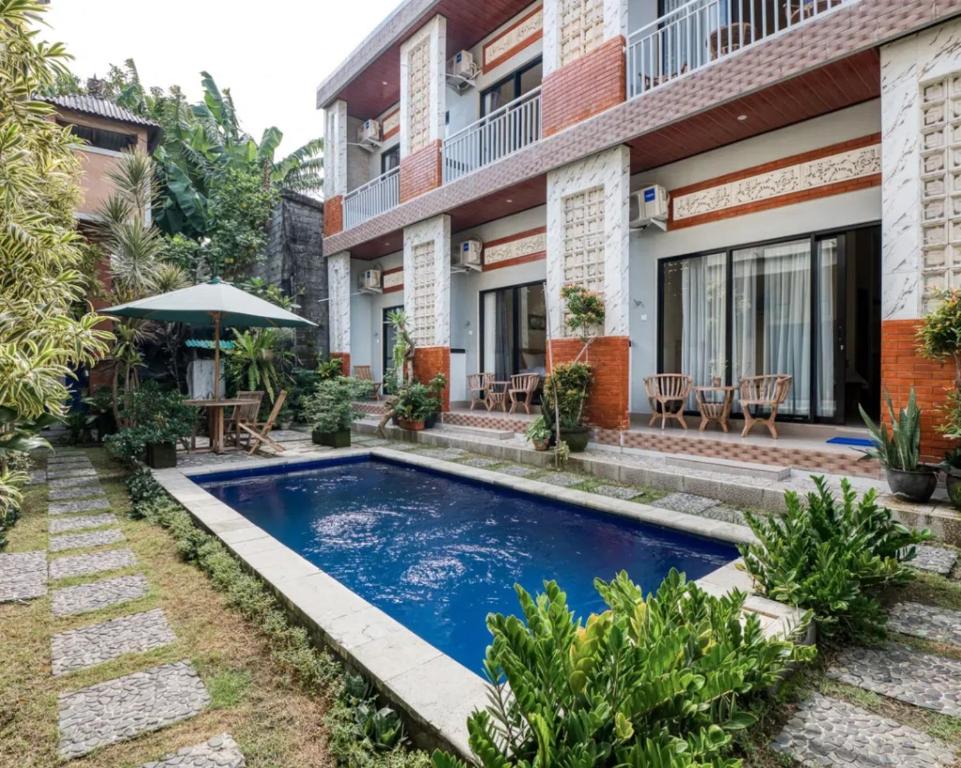 a swimming pool in front of a building at Dhita Kubu in Kerobokan