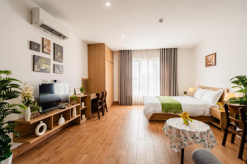 a hotel room with a bed and a television at Vari Homestay Đội Cấn in Hanoi