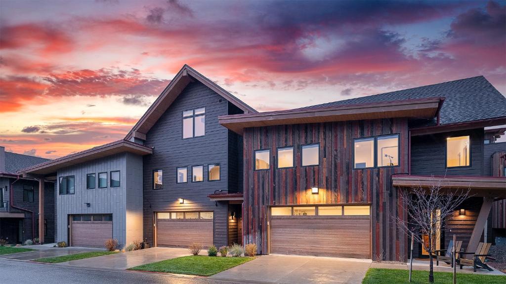 a large house with a sunset in the background at Princetown Grande in Steamboat Springs