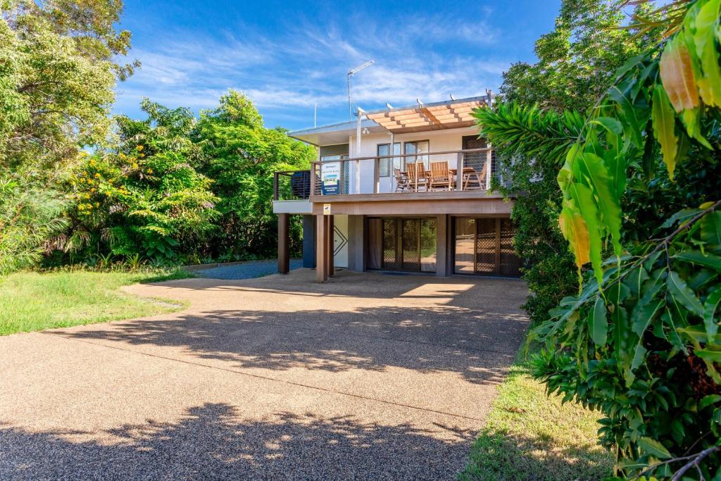 a large house with a porch and a driveway at 222 On Scenic in Yeppoon