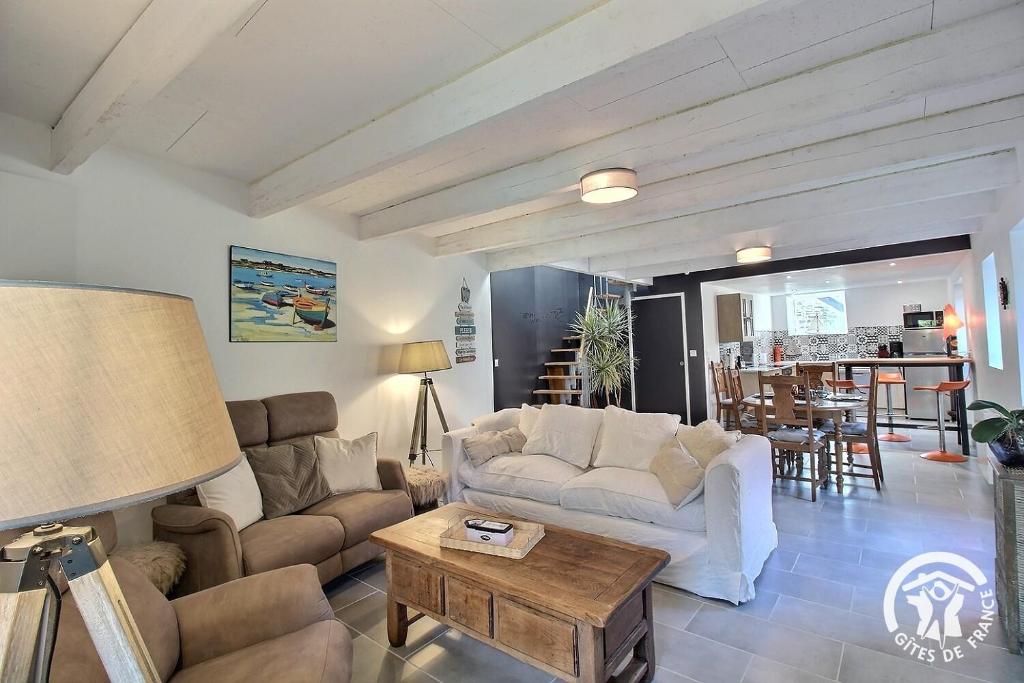 a living room with a couch and a table at Ty laouen in Le Légué