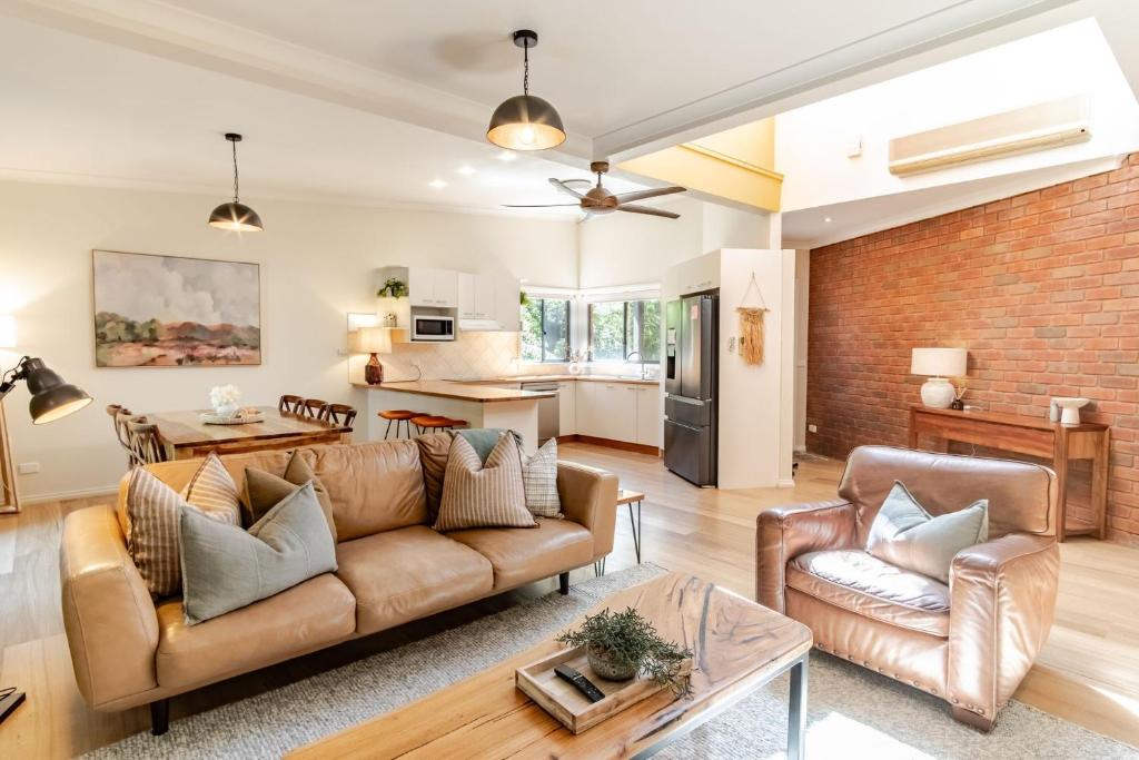 a living room with a couch and a table at Creek Haven in Bright