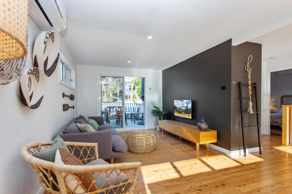 a living room with a couch and a table at Jimmys Beach House in Hawks Nest
