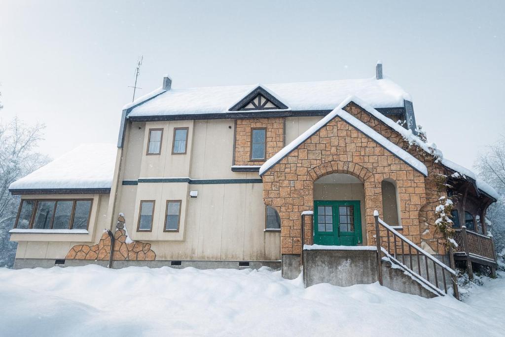 木島平村にあるKijimaBase - Base 1の雪の中の緑の扉のある家