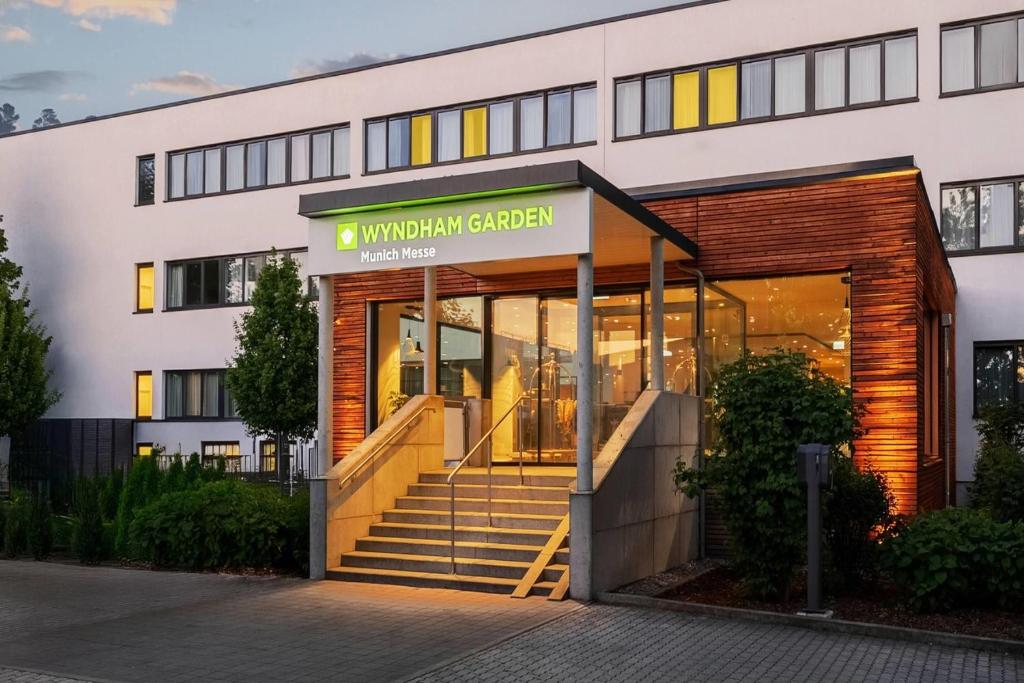 an office building with the entrance to a university garden at Wyndham Garden Munich Messe in Munich