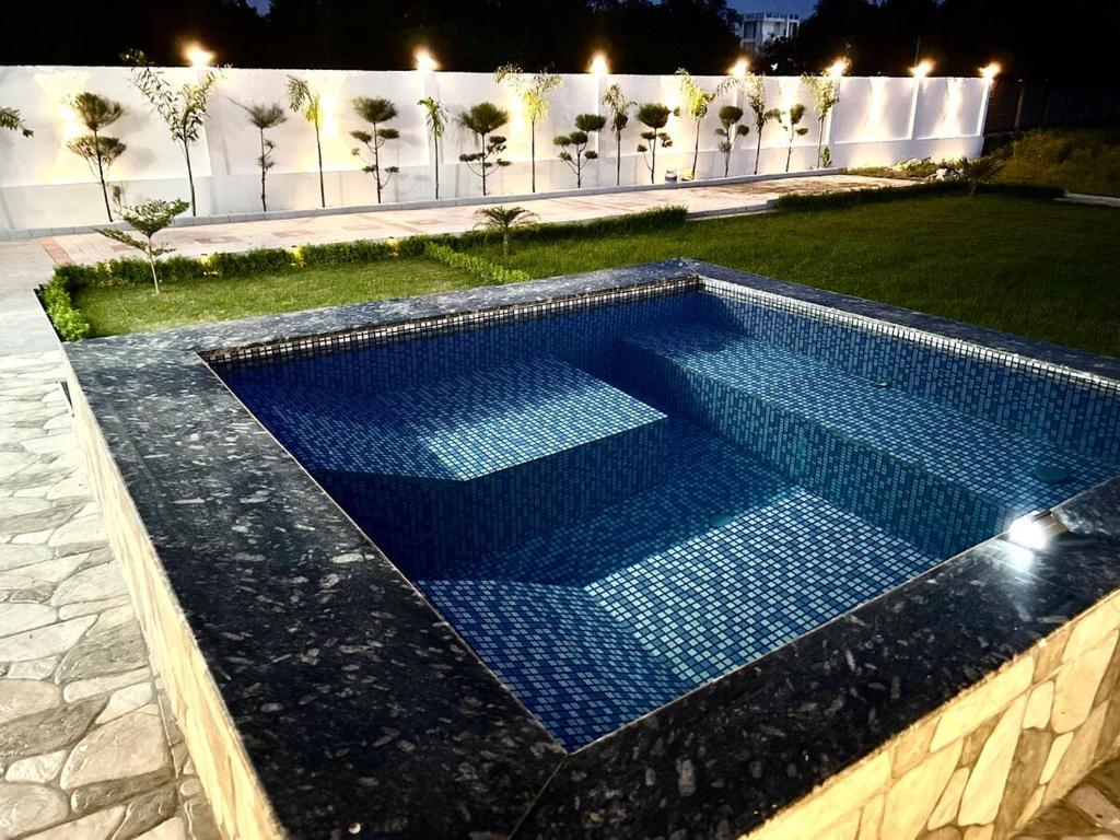 a swimming pool in a yard at night at Sandhika Retreat in Varanasi