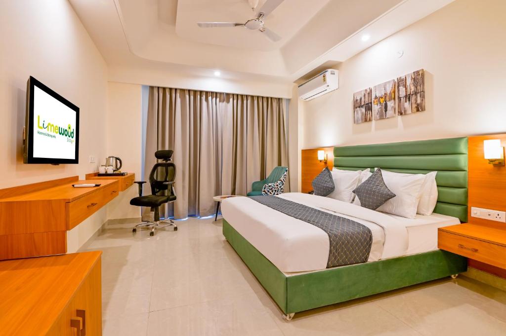 a hotel room with a bed and a desk at Limewood Signature - Golf Course Road in Gurgaon