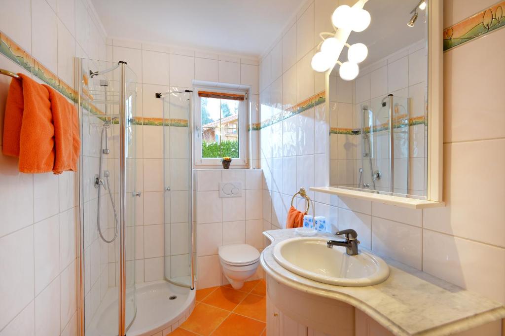a bathroom with a sink and a shower and a toilet at Appartement Horngacher in Scheffau am Wilden Kaiser