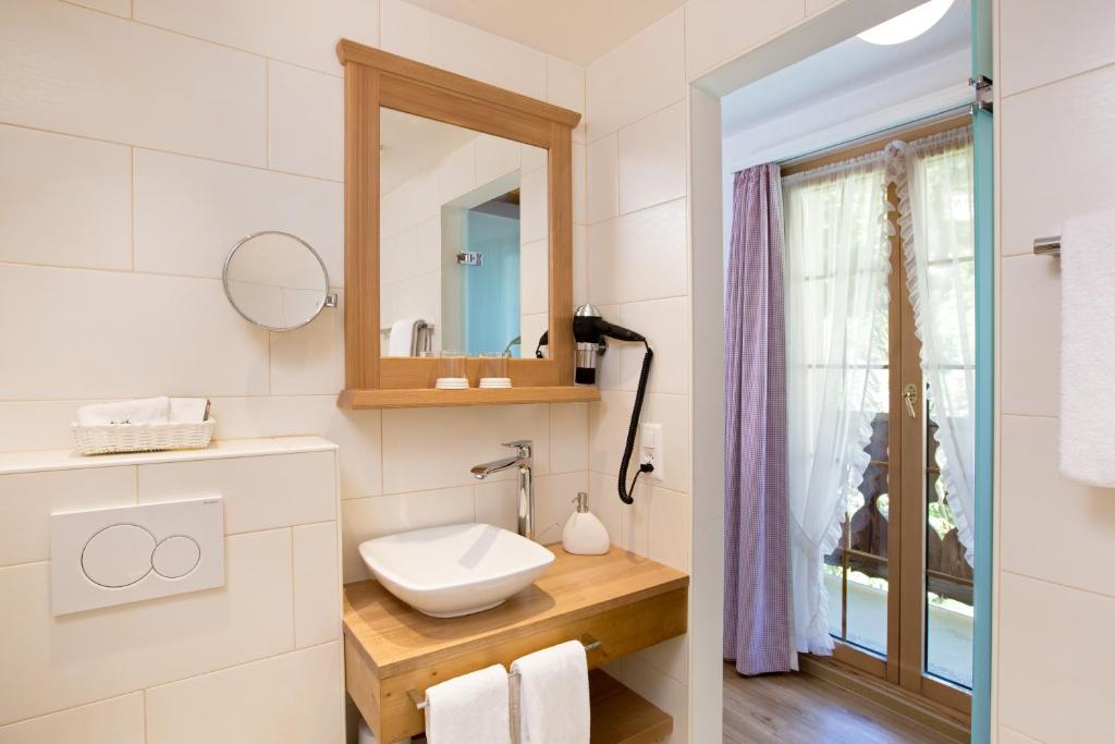 a bathroom with a sink and a mirror at Hotel Romantica in Zermatt