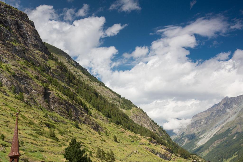 a view of a mountain with a church on the side at Hotel Romantica in Zermatt