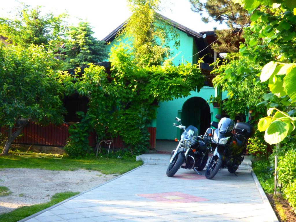 two motorcycles parked in front of a house at Vila Palma Palic in Palić