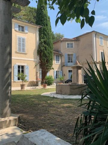 a large building in front of a house at Château Sainte BARBE in Loriol-du-Comtat