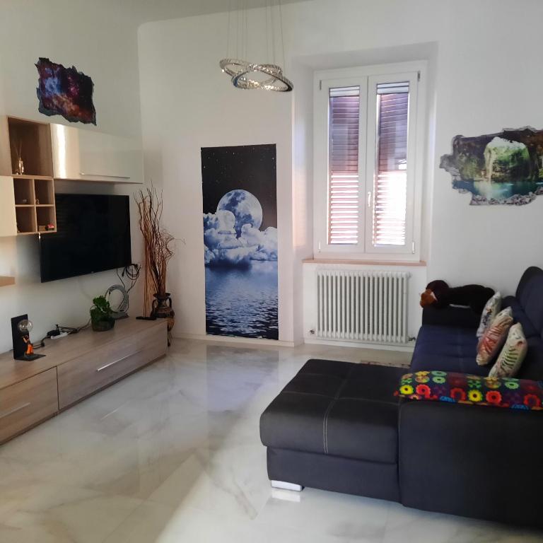 a living room with a couch and a television at Wellness at home in Ancona