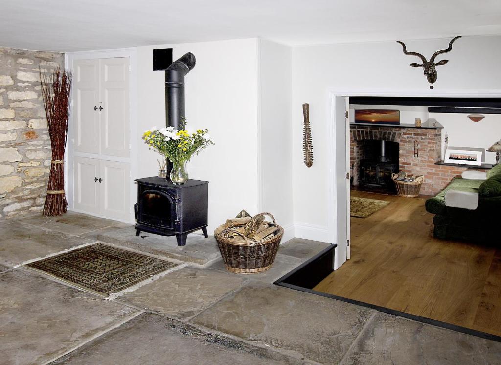 a living room with a fireplace and a stove at Rose Cottage in Lincoln
