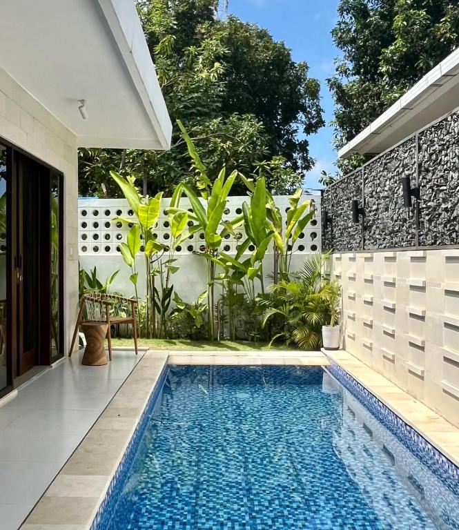 a swimming pool in the backyard of a house at Villa Kelle - Uluwatu Nusa Dua in Nusa Dua