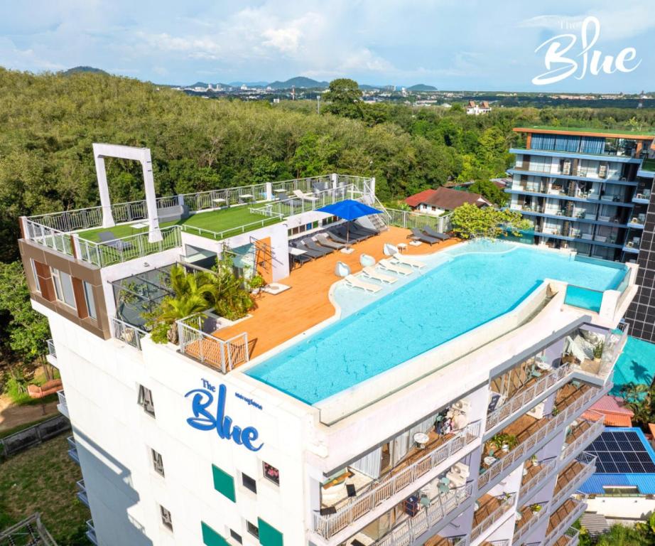 an aerial view of a building with a swimming pool at The Blue Hotel - SHA Plus in Chalong