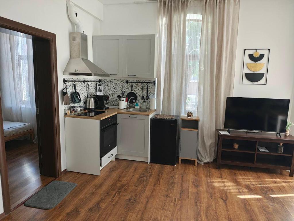 a kitchen with white cabinets and a counter top at Radomir Downtown 1-bedroom Apartment with balcony in Bŭnzareto