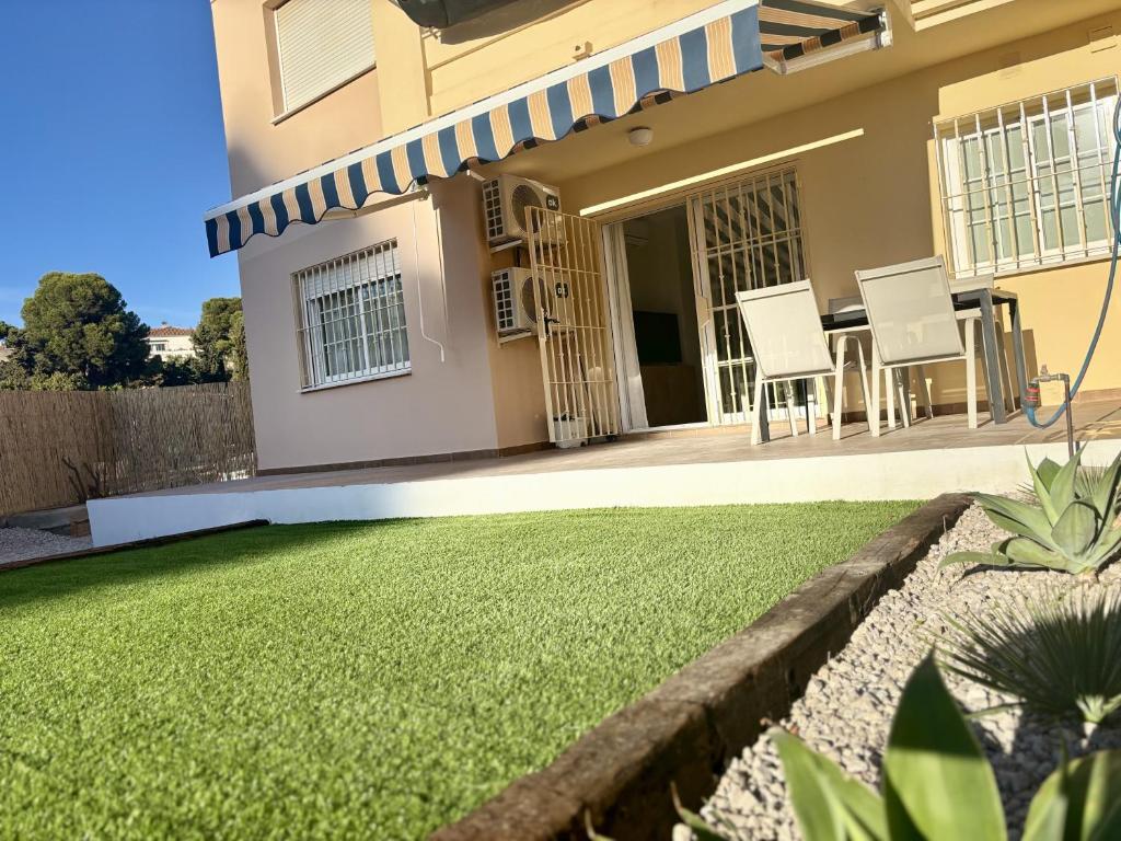 a house with a lawn in front of it at Apartamento Adelfa By Solymar Holiday in Benajarafe