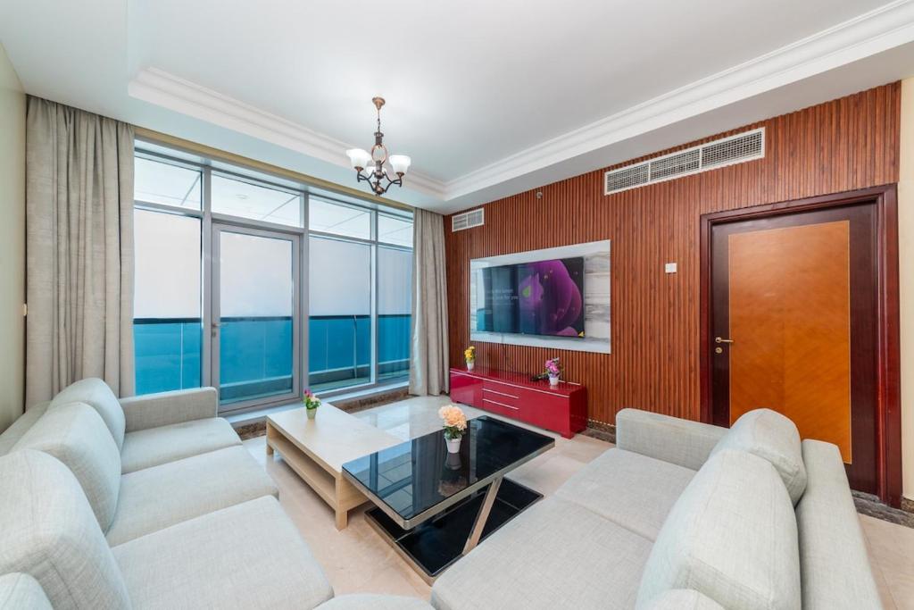 a living room with a couch and a table at Spacious 3BR Seaview Duplex Perfect for Families in Ajman 