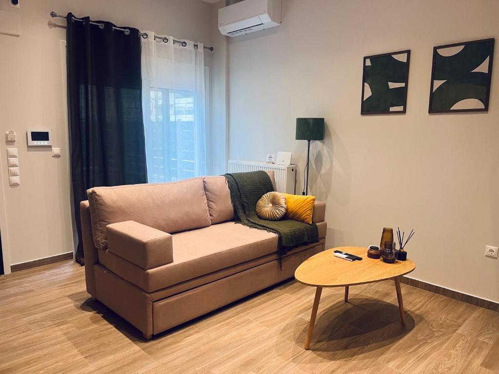 a living room with a couch and a table at Hodos Luxury APT 2 near ATH-Airport in Markopoulo