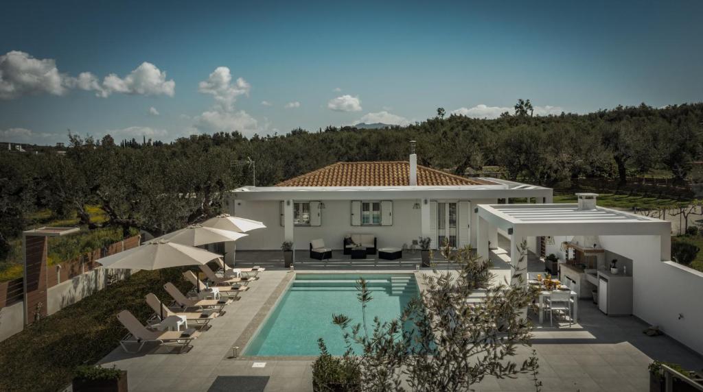 a villa with a swimming pool and a house at Deifilia Villa in Pandokrátor