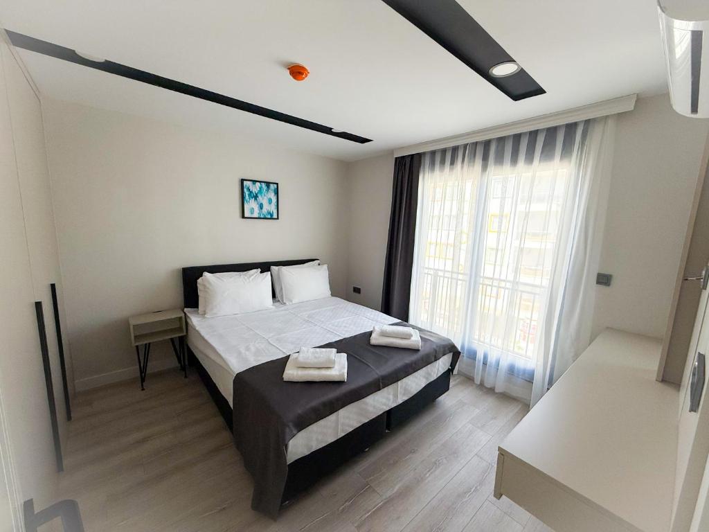 a bedroom with a bed and a large window at Moon City in Antalya