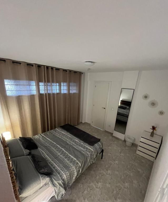 a bedroom with a bed and a large window at Safestay Calpe Seafront - Apartment Atlantico in Calpe