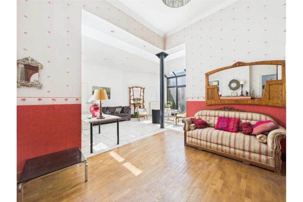 a living room with a couch and a table at Maison de Maître in Liège