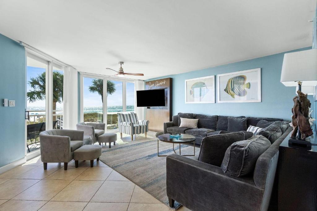 a living room with a couch and a tv at SeaSpray West 203-Gulf Front in Perdido Key