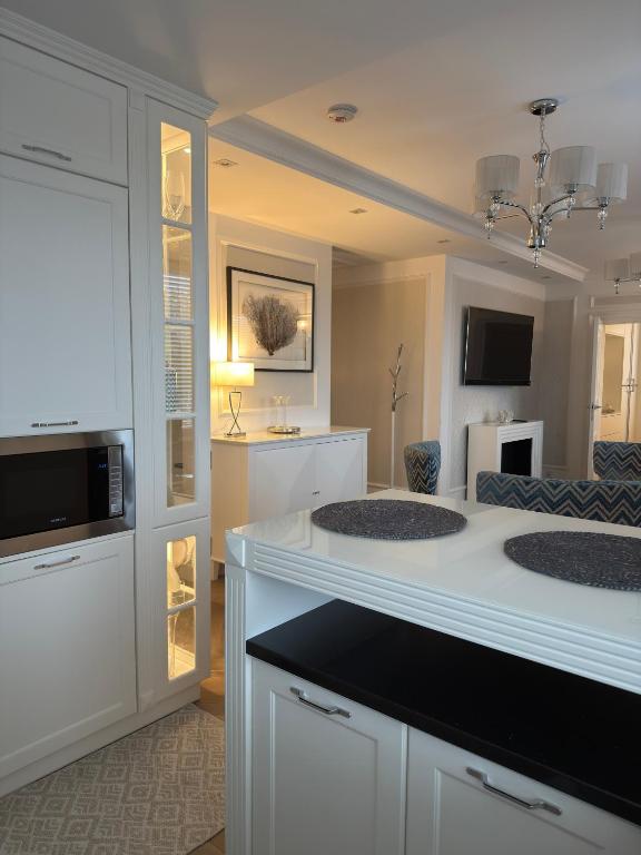a white bathroom with two sinks in a room at Apartament BIANCO Royal in Częstochowa