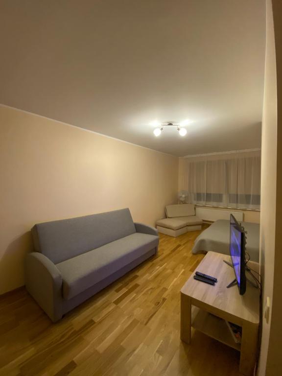 a living room with a couch and a table at Dzīvoklis Bauskā in Bauska