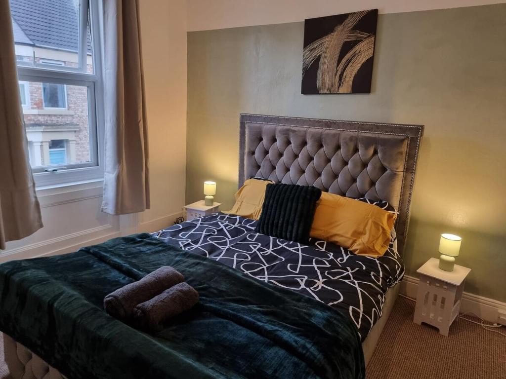 a bedroom with a large bed and a window at Sigma Elegance Free Parking in Tynemouth