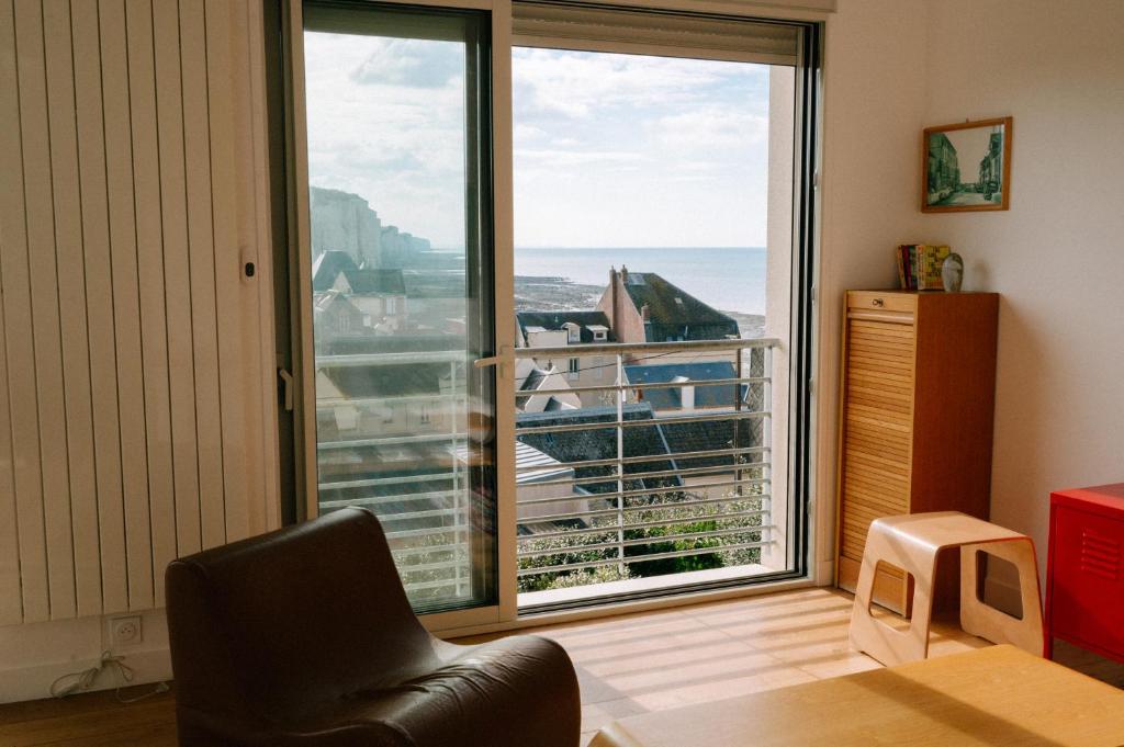 a room with a chair and a large window at Panorama XL Mer et Falaises à Ault in Ault