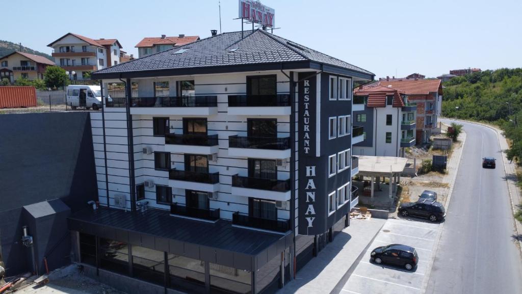 an apartment building with a black and white building at Мотел Ханай 