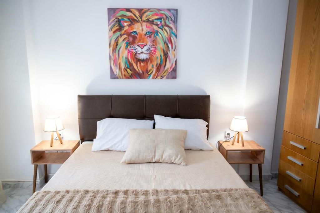 a bedroom with a bed with a painting of a tiger at Lion's Nest in Mesochórion