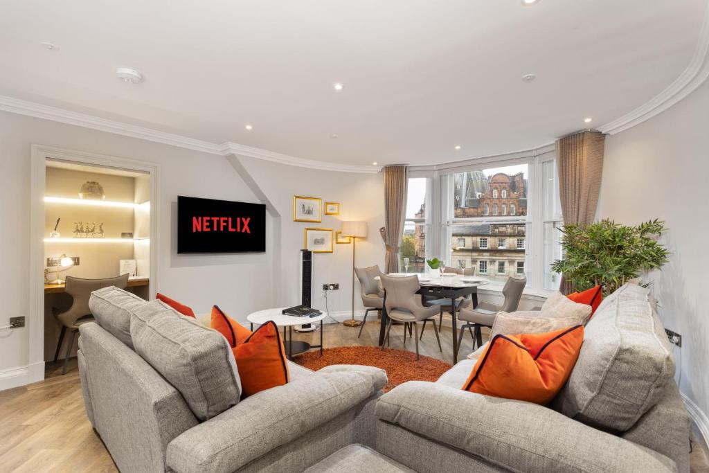 a living room with two couches and a dining room at Central Edinburgh Prime Luxury in Edinburgh