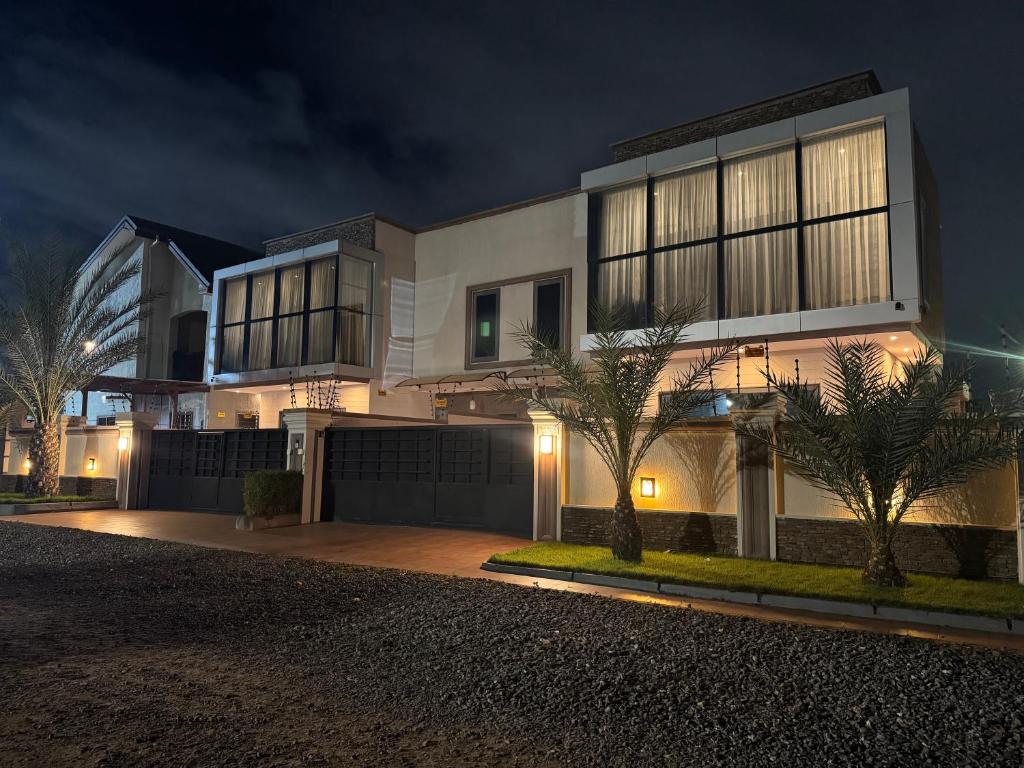 a large white house at night at Jupiter Villa 1 and 2 in Afienya