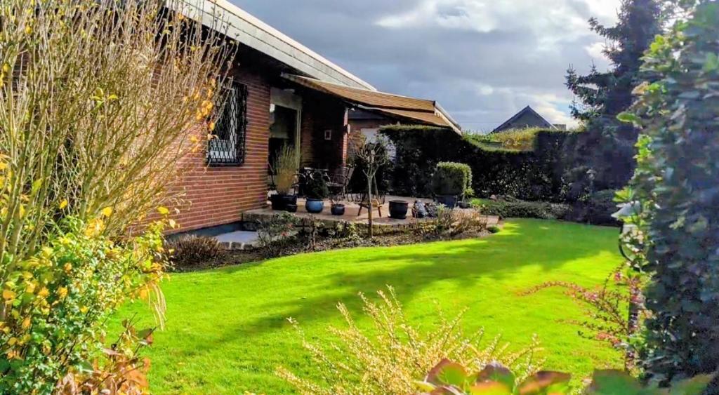 a house with a yard with a green lawn at Haus Wolfgang in Geldern