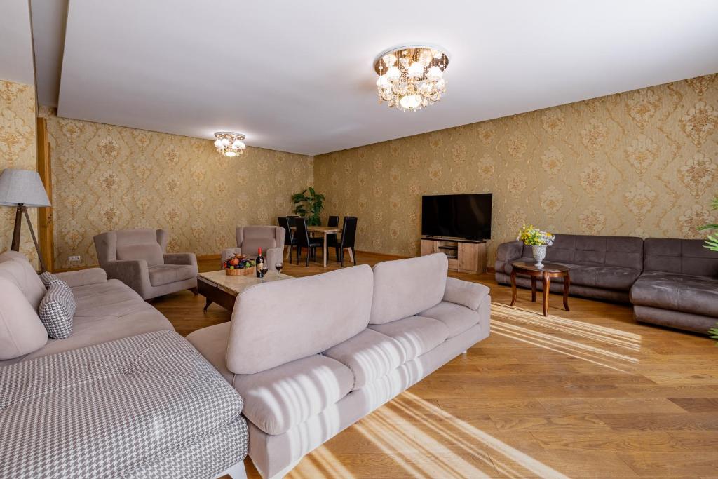 a living room with a couch and a tv at Fabulous Apartment in the City Center in Tbilisi City