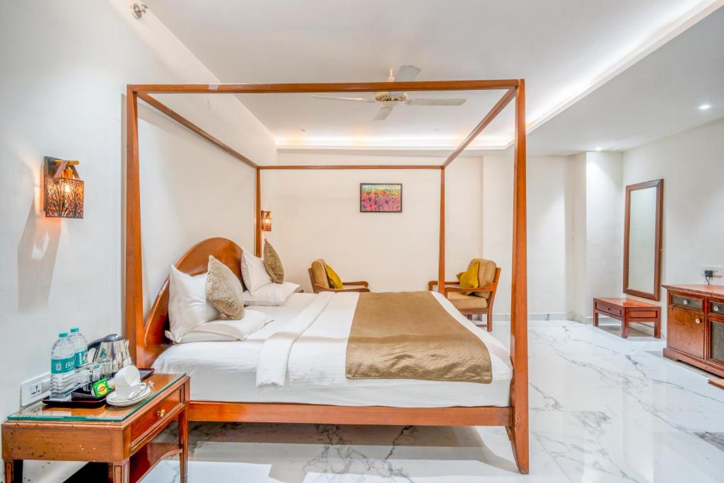 a bedroom with a large bed with a wooden frame at The White Seasons in Gwalior